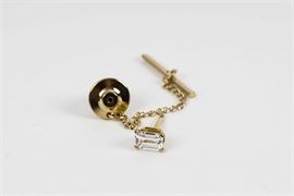18K Gold Tie Tack with Cubic Zirconia: An 18K yellow gold tie tack featuring a prong-set cubic zirconia stone, with a chain, bar and friction nut.