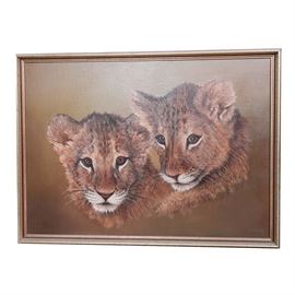 Faulkner Oil Painting of Lion Cubs: A Faulkner oil painting of lion cubs. Depicted in this oil painting on canvas is a pair of young lions. The painting is signed on the lower right “Faulkner”. It comes displayed in a wooden frame with a wire hanger on the reverse.