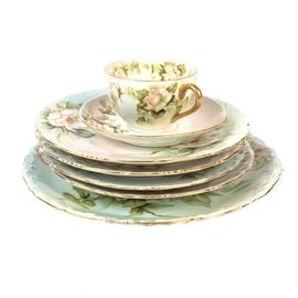 Limoges China: A collection of Limoges china. Featured here are seven pieces marked “T&V Limoges France Depose”. Included are a teacup and saucer, four salad plates and a dinner plate. All of the pieces are decorated with a pastel floral design and gold painted trim.