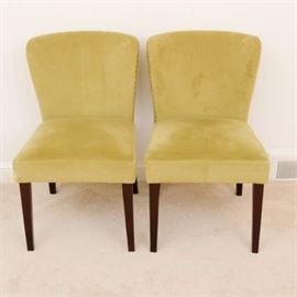 Pair of Slipper Chairs by Cost Plus Inc.: A pair of slipper chairs by Cost Plus Inc. These chairs feature a curved upholstered rectangular back with nailhead trim over an upholstered square seat that rises on tapered legs. The underside is marked “Cost Plus Inc.”