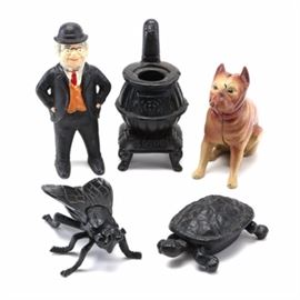 Cast Iron Metal Figures: An assortment of cast iron figures. Included are a standing man wearing a bowler hat, a sitting bulldog, and a pot-bellied stove. Also, an insect and turtle boxes with hinged lids.