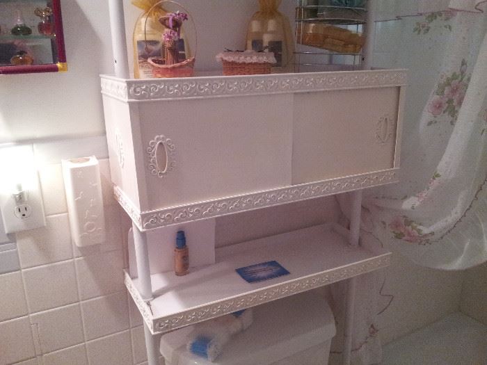 Over the toilet shelf unit with lotions, figurines.  there is one in each bathroom and filled with great bath care items