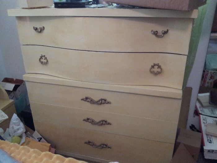 Look at the details. 3 sets of different handles, curved drawers, heavy unparalled construction.  Lots of storage