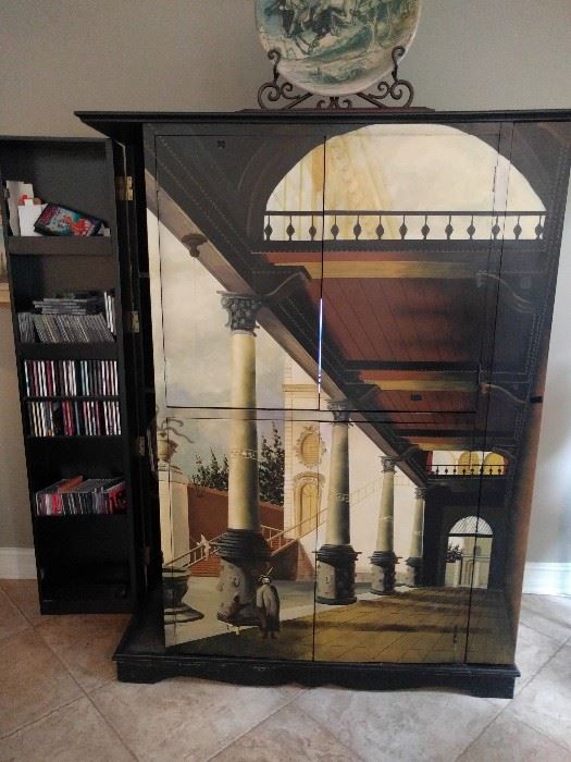 Hand painted entertainment armoire, with two door that open on each side (left side is open) to hold albums, CD's, 8-tracks and odd Hot Wheels cars.
