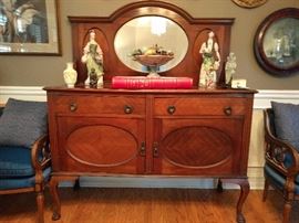 Lovely 1930's mahogany sideboard, with matched veneers, topped by a pair of vintage Cybis figurines, and a huge Holbein book "The Queens Collection at Windsor Castle".