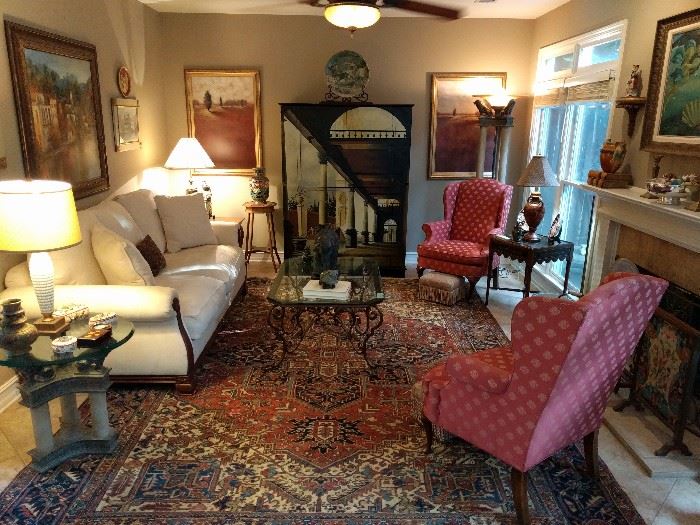 Lovely living room, with lot's of art, anchored by a 10' x 13' Persian Heriz rug, pair of wingback armchairs, hand painted Italian chest, torchiere & matching side table, heavy wrought iron/beveled glass coffee table, etc.