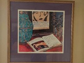 Work of art by the America artist Michele Richard Kennedy has art within art.  It is a limited edition print of her painting honoring the great 20th century French master Matisse.                                                                    A book in the foreground is open to a reproduction of a Matisse Reclining Nude in the Museum of Modern Art.  Above that is a framed poster from a 1950 Matisse exhibition in Paris at the Maison de la Pensee Francaise.  An exotic pottery jar is at the left and a glass or crystal vase with purple flowers is at the right.  This is a signed copy, # 410 of 1,500.