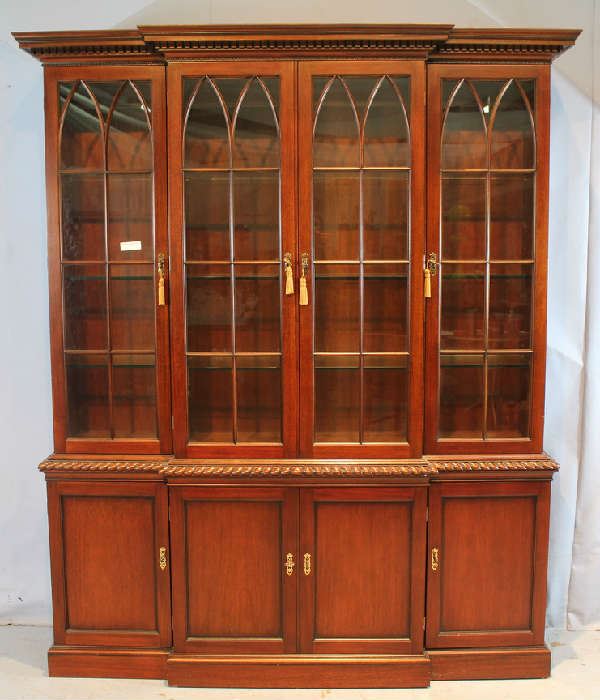 33 - large mahogany 2 piece breakfront with individual pane glass panels, lighted with gadrooned trim, 7 ft. T, 68 in. W, 16 in. D.