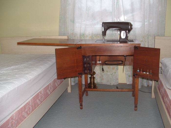 Vintage sewing machine cabinet with knee lever control sold with sewing machine only.