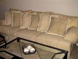 Very large cream colored sofa with loose back pillows. Never been used!