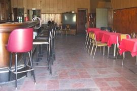 Tall and short vinyl padded chrome chairs, tables, table cloths, large TV.