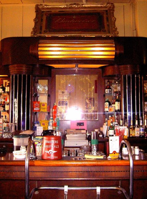 Center of bar showing light and gold leafed mirrors.