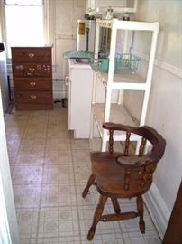 Kitchen with sink, cupboards, dresser, chair.