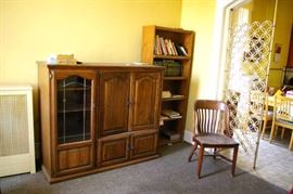 Entertainment center, bookcase, books, antique wood chair.
