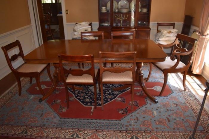 Gorgeous Duncan/Hepplewhite Double Pedestal Dining Table with 8 Beautiful Dining Room Chairs also in Background is a glimpse of the Lovely Matching Hepplewhite China Cabinet all elegantly displayed upon a  Romanian Serapi Rug 