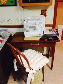 Shark EuroPro Sewing Machine with Accessories.  We also have a small sewing table with matching chair.