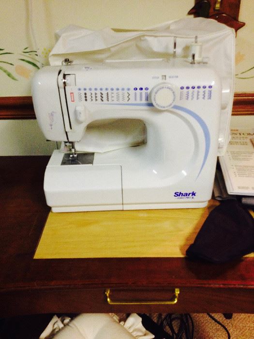 Shark EuroPro Sewing Machine with Accessories.  We also have a small sewing table with matching chair.
