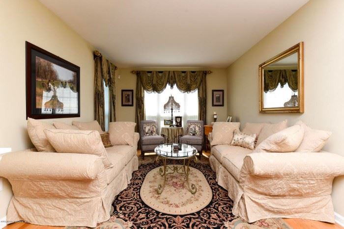 Aubusson rug, glass and brass coffee table, mirrors, lamps