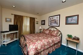 Iron bed frame. Bedding.