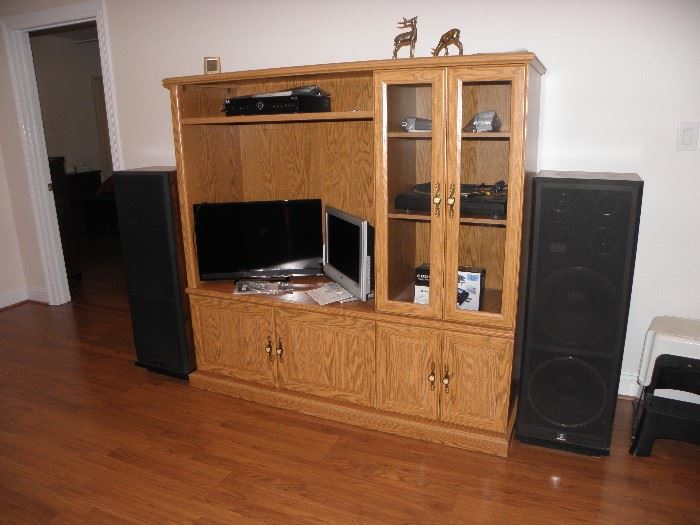 Oak tv/stereo cabinet, glass front.  Sherwood speakers, two flat screen personal size tvs.  Sherwood turntable
