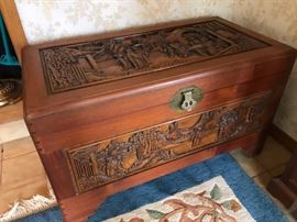 Heavily hand carved trunk with pristine interior and sliding shelf. There is also carving on all 4 sides!