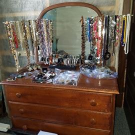 Vintage dresser displaying a nice assortment of costume jewelry
