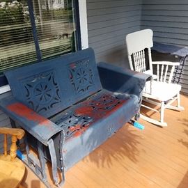 Loveseat size glider.  Has some rust, but it's a rare size.  White rocker, and a painted vintage table