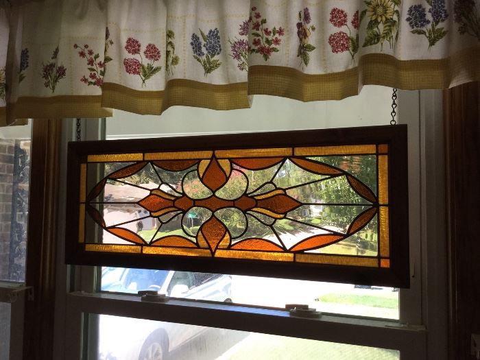 Framed stained glass window panel.