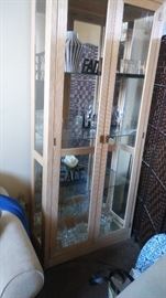 Beautiful display cabinet with interior lighting and glass shelves.Brand is America of Martinsville.