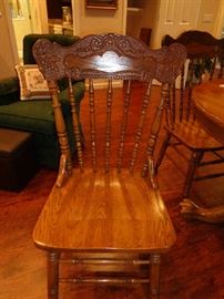 closeup of reproduction pattern back oak chairs