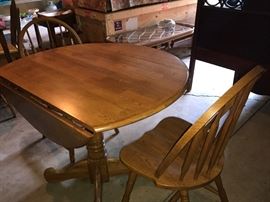 round oak drop leaf table and two chairs