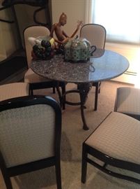 Cast iron base granite top table, six lacquer chairs