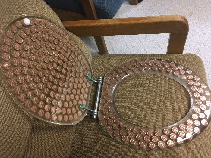 Pennies in lucite commode/toilet seat.  Standard round. 