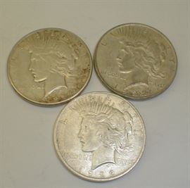 Three circulated 1922-D U.S. Peace dollars.