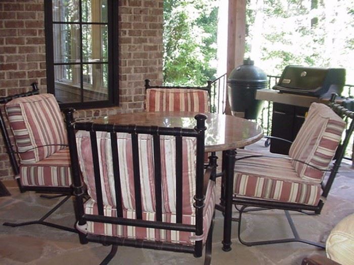 Marble top table and four wrought iron chairs with cushions