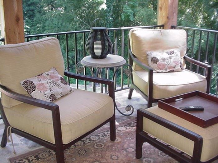 Wrought iron porch furniture--two club chairs and ottoman + ornate occasional table between chairs with stone top