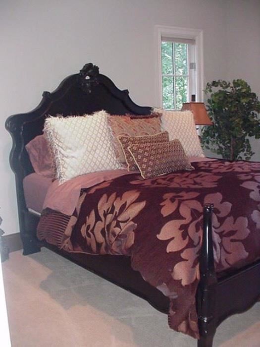 Queen sized bed with carved headboard and footboard with modified posters