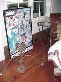 Positano poster, framed; chandelier on floor in front of poster