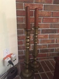 Tall brass candlesticks with teak candles