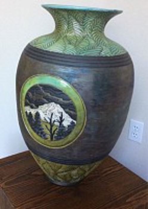 Large Christopher Mathie Raku urn with landscape vignet of a snowy Mt. Rainier and trees, with leaf patterning around top and bottom, measures 24.75 H x 15 W x 15 D inches, 1998, signed and titled on bottom.