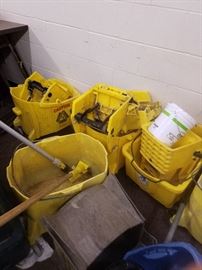 Commercial buckets with mop squeezer and handles.  Bright Yellow on rollers.