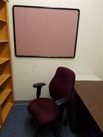 office chair on rollers, reminder board in backround
