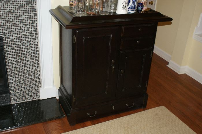 Dark stained bar with keys to lock doors