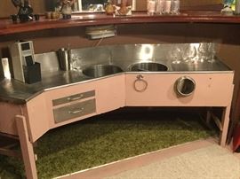Tinned wash bar with two sinks, cutting board, drainboards.