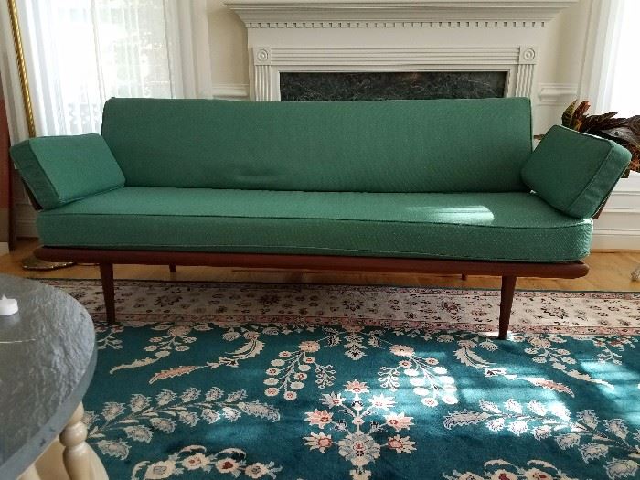 this couch is red... the green slipcover was in poor condition and was discarded.  leaving pic up to see the lines of the couch