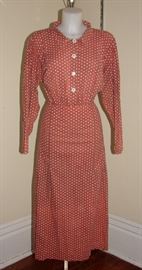 1930s-1040s house dress in a rust color with polka dots.