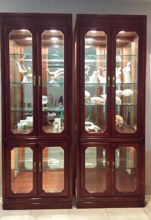 Two lighted china cabinets with beveled glass. 