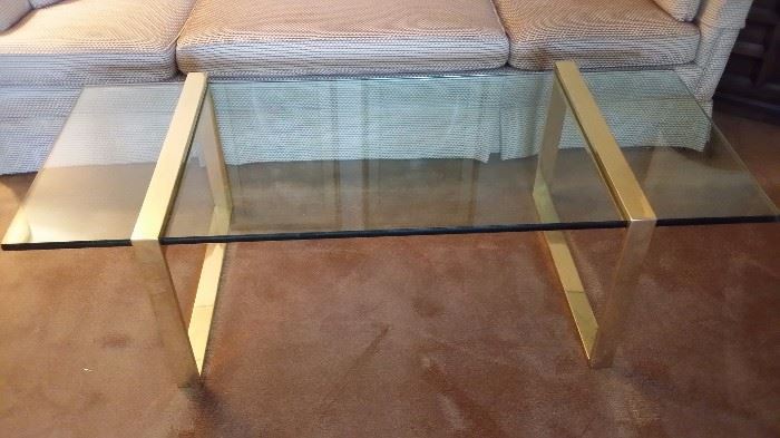 Glass coffee table with brass legs 