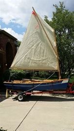 11 foot handmade Arch Davis Sand Dollar sailboat with lapstick sides.  Trailer and accessories included.