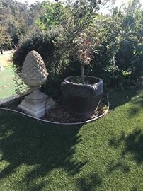 Giant cement statuary and potted plants